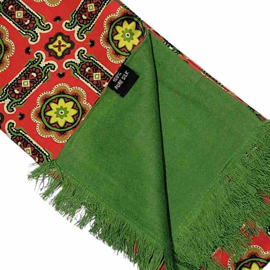 Tootal silk scarf with red background, geometric pattern and green fringe with corner folded back to show the green brushed silk back