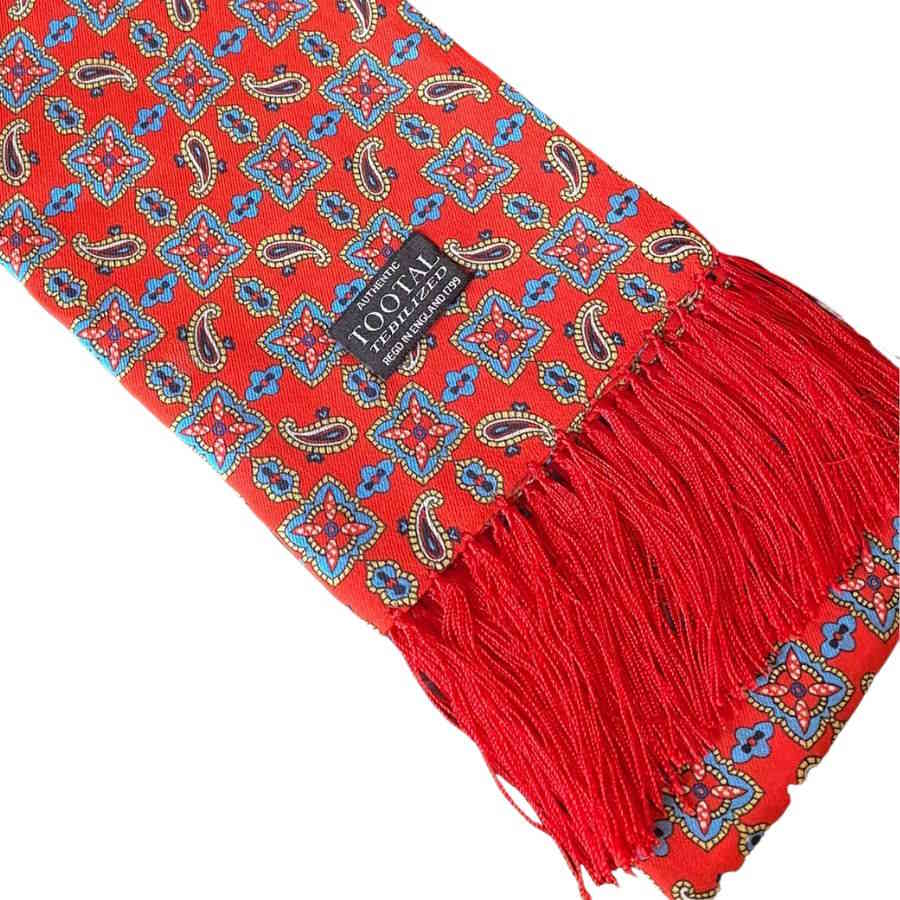 Red tootal rayon scarf with paisley and geometric tile print. Red tassel fringe. 