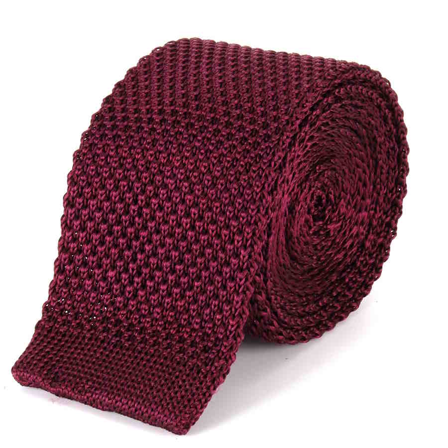 Burgundy knitted silk tie rolled up with the straight edge end showing